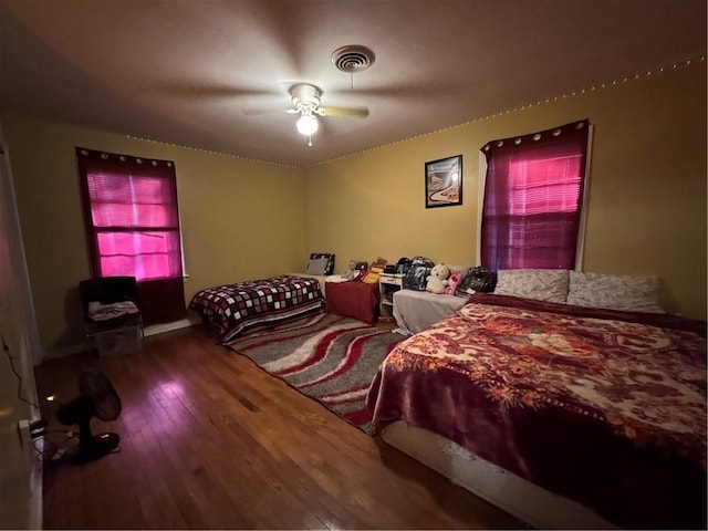 bedroom with ceiling fan and hardwood / wood-style floors