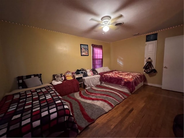 bedroom with ceiling fan and hardwood / wood-style floors