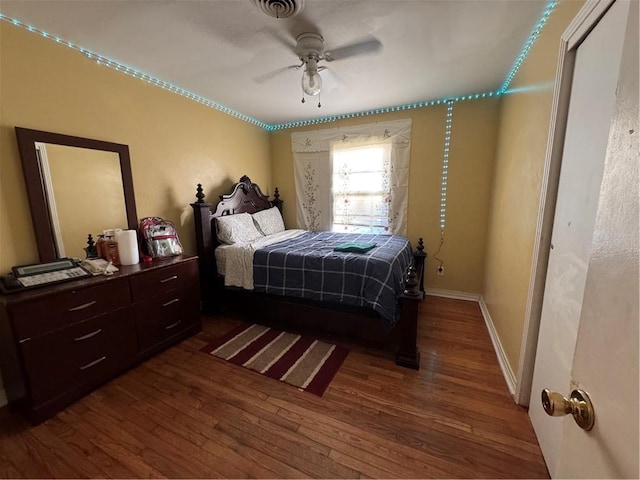 bedroom featuring ceiling fan and dark hardwood / wood-style floors