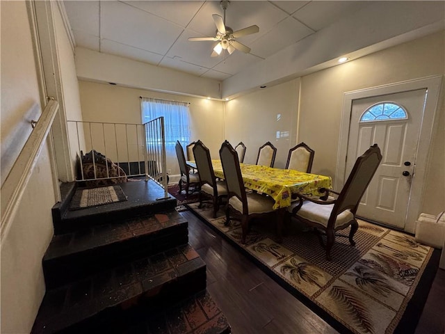 dining space with ceiling fan and dark hardwood / wood-style flooring