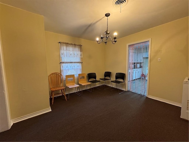 carpeted office space with a chandelier