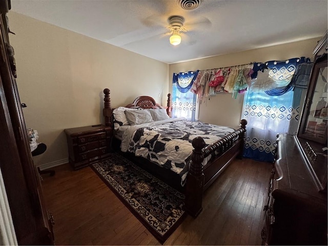 bedroom with ceiling fan and dark wood-type flooring