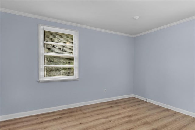 empty room featuring crown molding and light wood-type flooring