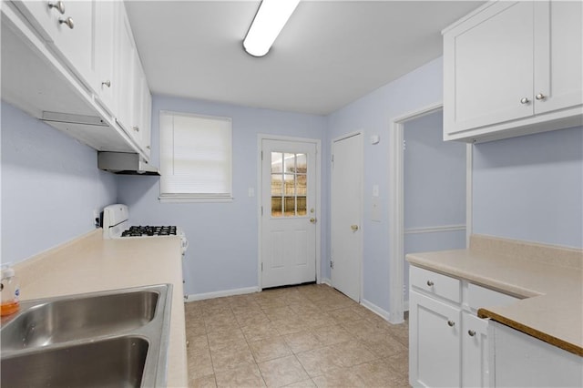 kitchen featuring white cabinetry and sink