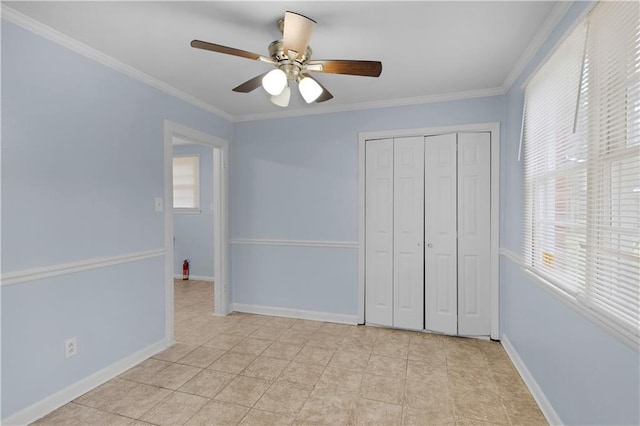 unfurnished bedroom with ornamental molding, light tile patterned flooring, ceiling fan, and a closet