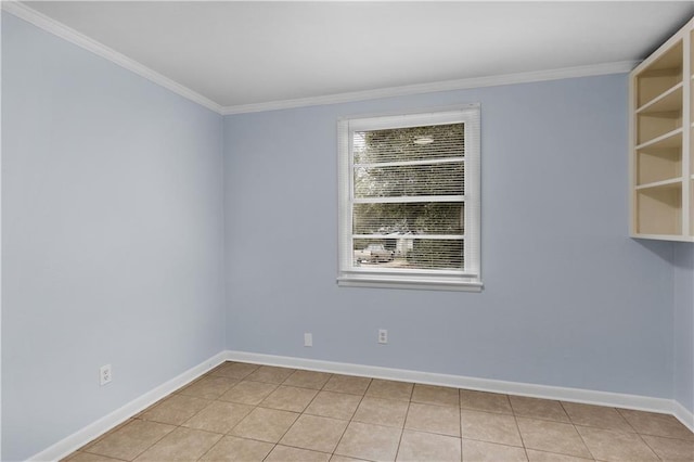 tiled empty room featuring crown molding