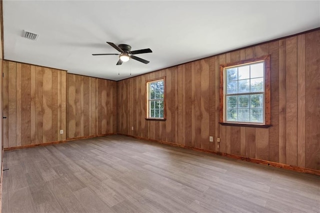 8520 Lebaron Ave W, Citronelle, AL 36522 - unfurnished room featuring wood finished floors, ceiling fan, and wood walls