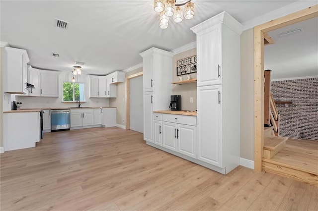 8520 Lebaron Ave W, Citronelle, AL 36522 - kitchen with dishwasher, white cabinetry, light wood-type flooring, a chandelier, and light countertops