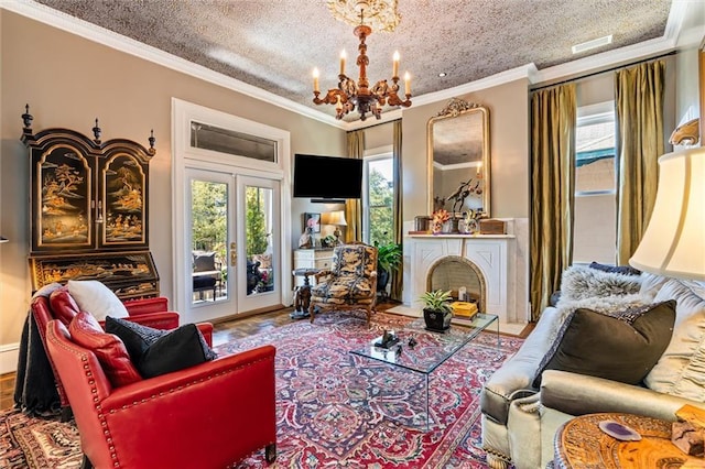 living area with a notable chandelier, a fireplace with flush hearth, a healthy amount of sunlight, and ornamental molding