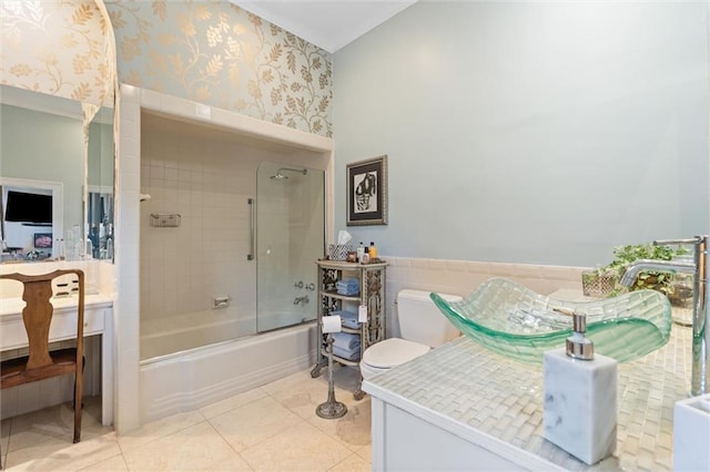 bathroom featuring wallpapered walls, wainscoting, tile patterned flooring, enclosed tub / shower combo, and vanity