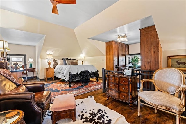 bedroom featuring baseboards, dark wood-type flooring, and lofted ceiling