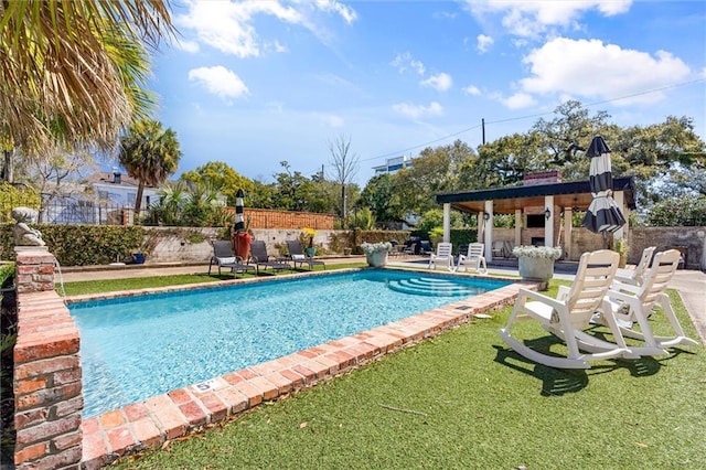 view of pool featuring a yard, a fenced in pool, a patio, and a fenced backyard