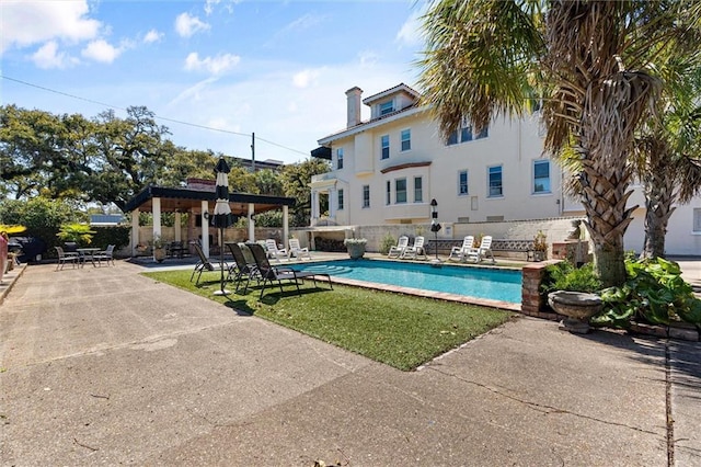 outdoor pool with a patio area