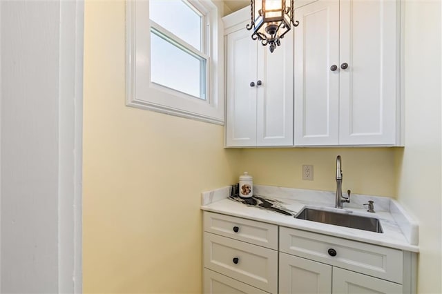 interior space featuring hanging light fixtures and a sink