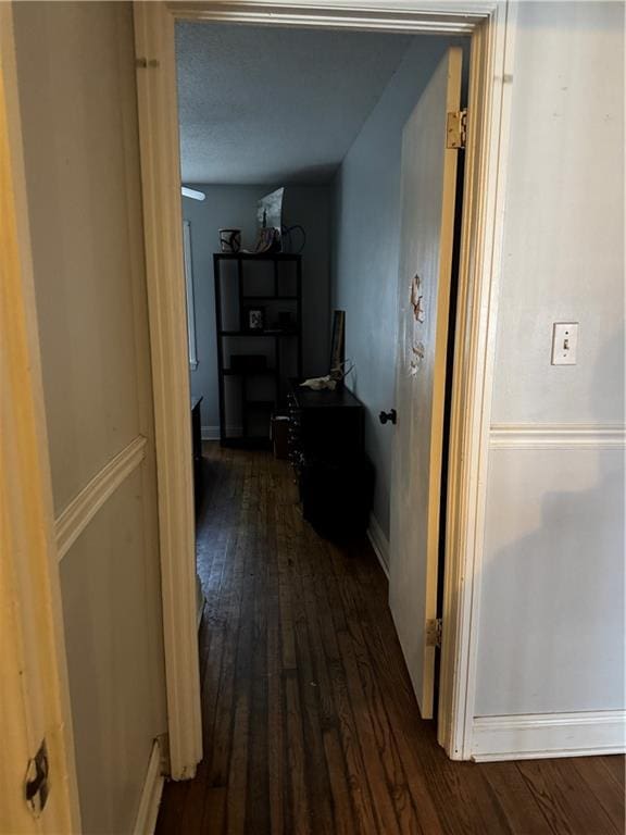 corridor featuring dark hardwood / wood-style flooring