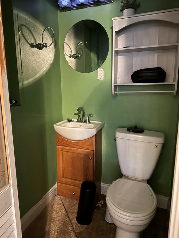 bathroom featuring toilet and vanity