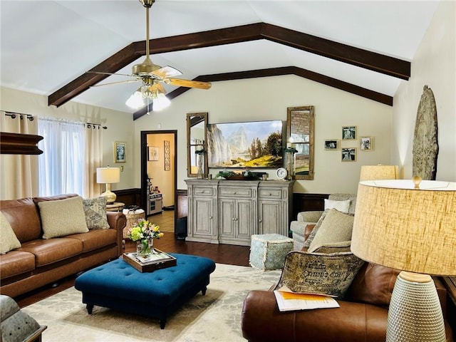 living area featuring vaulted ceiling with beams, dark wood finished floors, and a ceiling fan