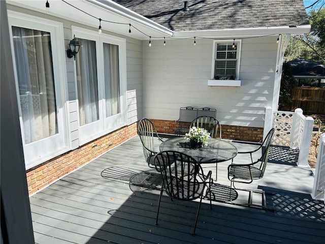 wooden terrace with outdoor dining space