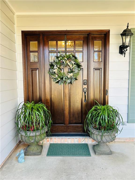 view of exterior entry with covered porch