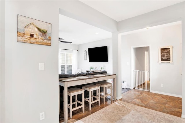 interior space featuring ceiling fan