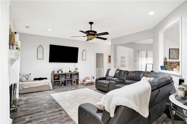 living room featuring dark hardwood / wood-style flooring and ceiling fan