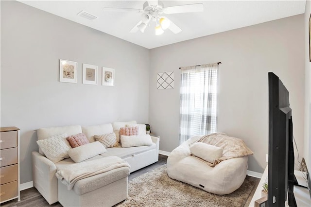 living room with ceiling fan and wood-type flooring