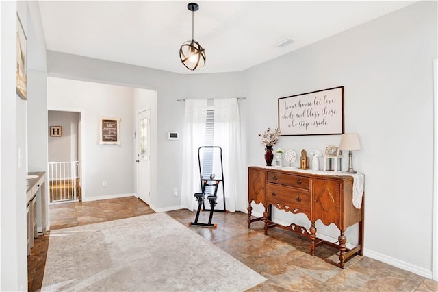 foyer entrance with a notable chandelier