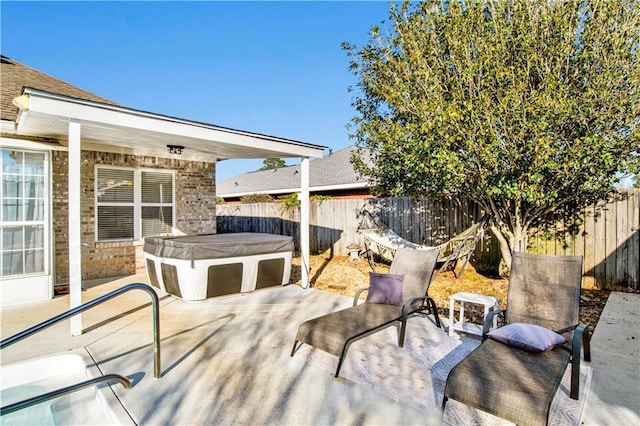 view of patio / terrace with a hot tub