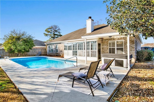 view of pool featuring a jacuzzi and a patio