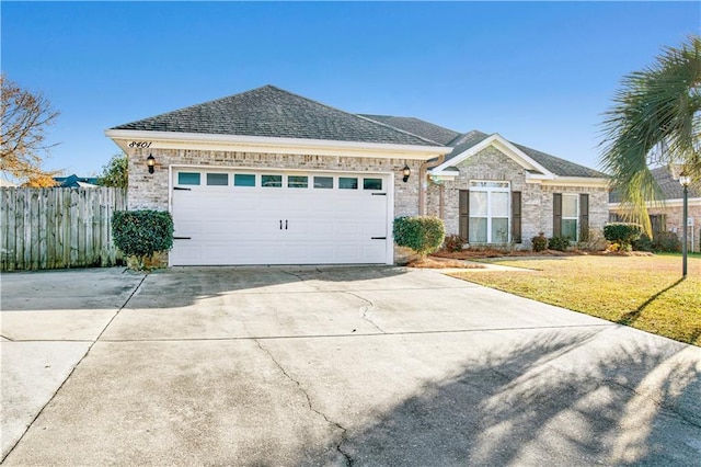 view of front of property with a garage and a front lawn