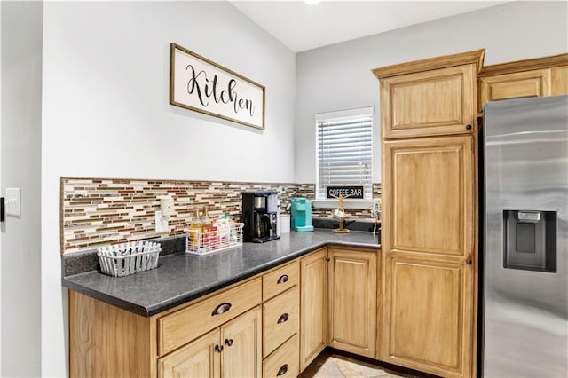 kitchen with decorative backsplash and stainless steel refrigerator with ice dispenser