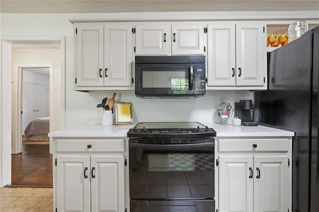 4950 Santos Dr E, Mobile, AL 36619 - kitchen featuring black appliances, light countertops, and white cabinets
