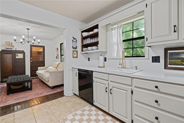 4950 Santos Dr E, Mobile, AL 36619 - kitchen with dishwasher, a sink, light countertops, a chandelier, and white cabinetry
