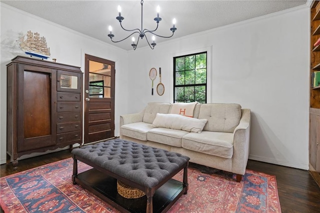 4950 Santos Dr E, Mobile, AL 36619 - living room with a chandelier, dark wood finished floors, ornamental molding, baseboards, and a textured ceiling