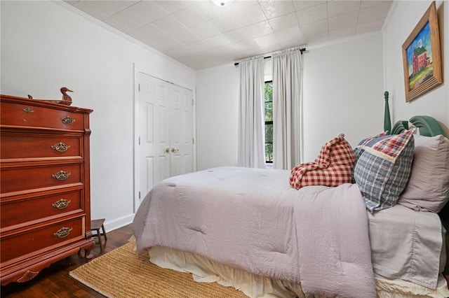 4950 Santos Dr E, Mobile, AL 36619 - bedroom featuring ornamental molding, dark wood-type flooring, and a closet
