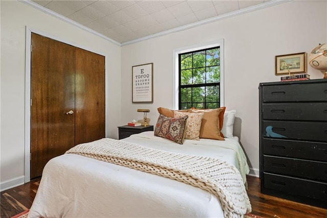 4950 Santos Dr E, Mobile, AL 36619 - bedroom with ornamental molding, dark wood finished floors, a closet, and baseboards