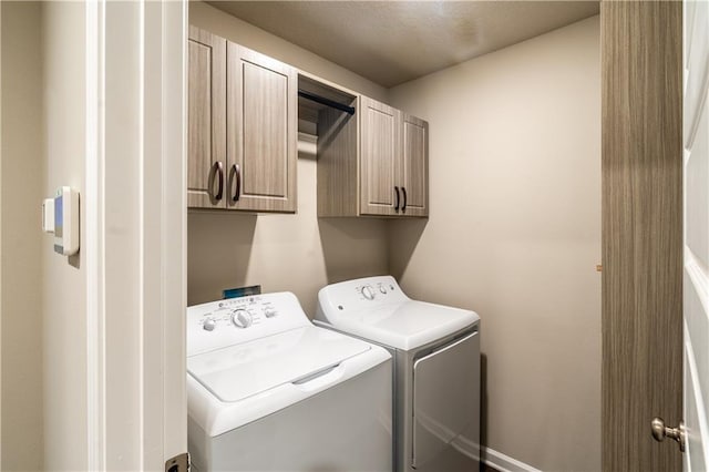 laundry area with cabinet space and washer and clothes dryer