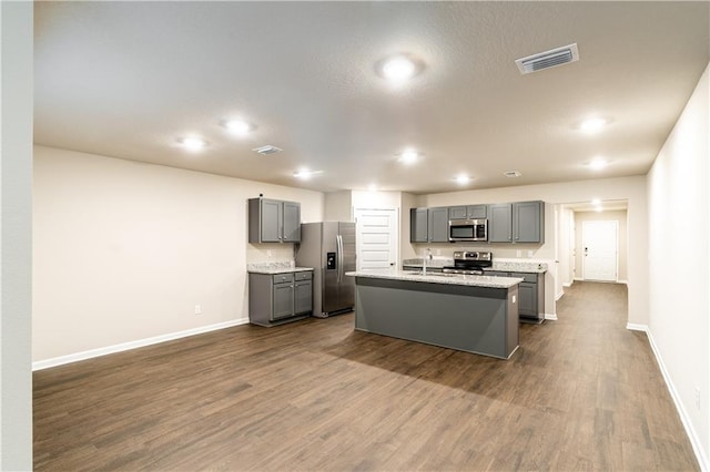 kitchen with dark wood-style floors, visible vents, appliances with stainless steel finishes, and gray cabinetry