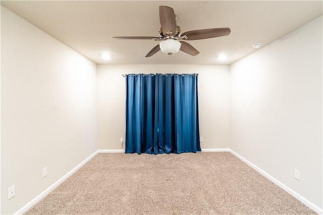 unfurnished room featuring carpet floors, ceiling fan, and baseboards