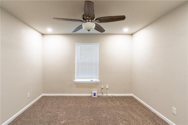 carpeted empty room with ceiling fan and baseboards