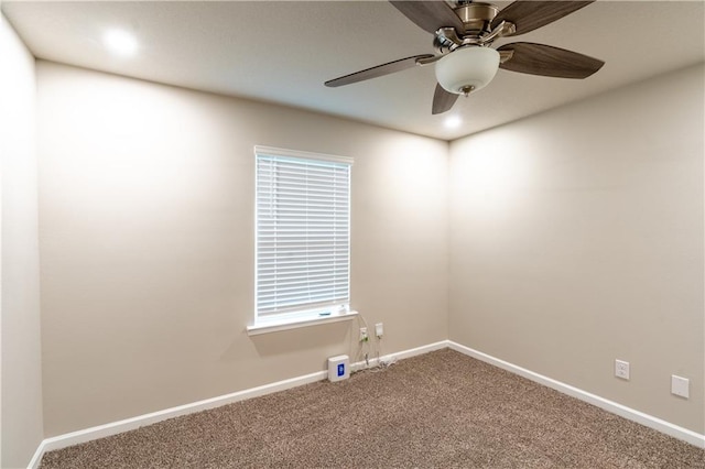 spare room with carpet flooring, ceiling fan, and baseboards