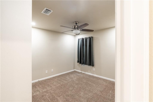 spare room with baseboards, carpet flooring, visible vents, and a ceiling fan