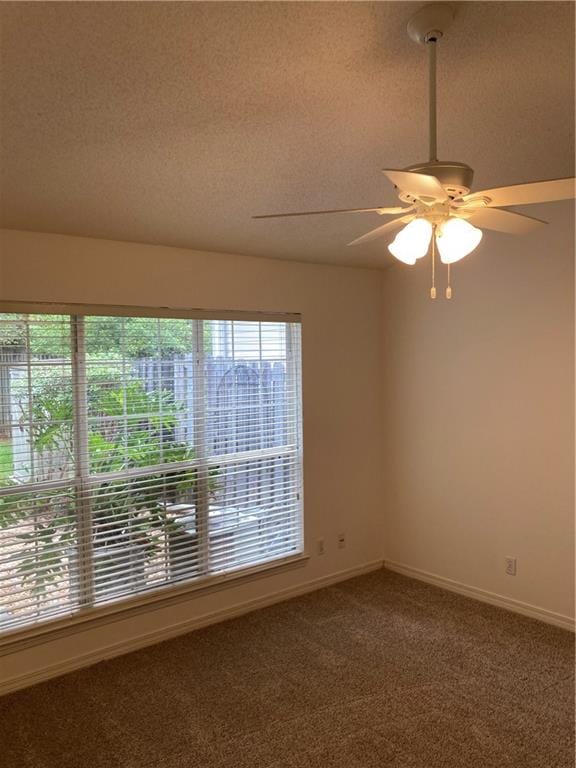 unfurnished room with ceiling fan, a textured ceiling, and carpet flooring