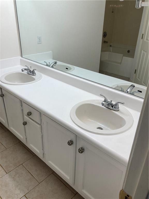 bathroom featuring double vanity,  shower combination, and tile patterned flooring