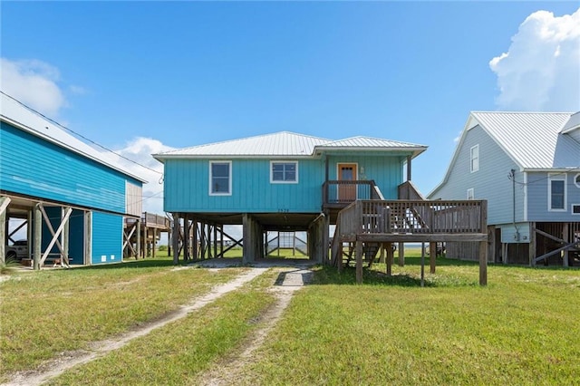 2528 Bridgeview Dr, Dauphin Island, AL 36528 - back of house featuring a carport, driveway, stairs, a lawn, and a metal roof