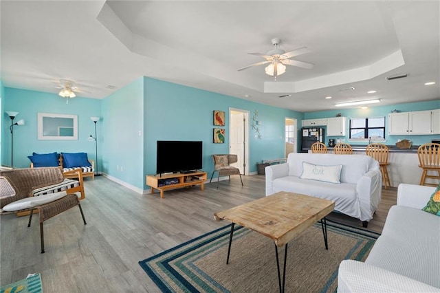 2528 Bridgeview Dr, Dauphin Island, AL 36528 - living room featuring a ceiling fan, a raised ceiling, light wood-type flooring, and recessed lighting