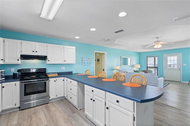 2528 Bridgeview Dr, Dauphin Island, AL 36528 - kitchen featuring electric range, under cabinet range hood, a peninsula, recessed lighting, and dark countertops