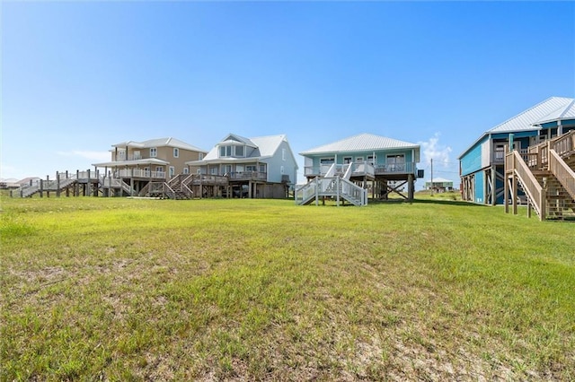 2528 Bridgeview Dr, Dauphin Island, AL 36528 - view of grassy yard featuring stairs and a deck