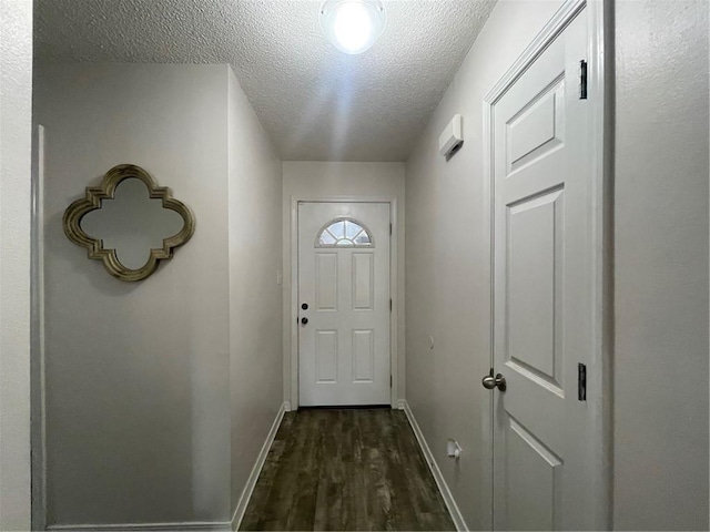 entryway with dark hardwood / wood-style floors and a textured ceiling