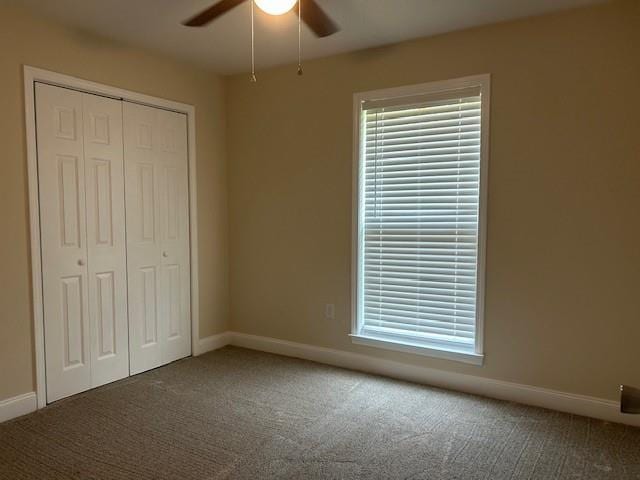 13580 Laco Cooper Rd, Wilmer, AL 36587 - unfurnished bedroom with a closet, carpet floors, baseboards, and ceiling fan
